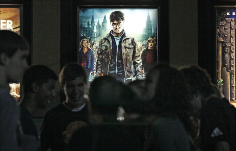 Moviegoers wait for the midnight showing of 