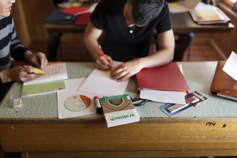 Asylum seekers write into their excercise books during German lessons in a converted classroom, photographed in a temporary housing in Rigi-Kloesterli, in the Canton of Schwyz, Switzerland on April 20, 2016. During the shoulder season asylum seekers house in a repurposed vacation lodge, provided by the charitable organization Caritas, in Rigi-Kloesterli. At the moment of documentation, 14 out of 50 available spots were taken by asylum seekers from Sri Lanka, Afghanistan and Iran. They study German and carry out domestic and cleaning work, or assist in the kitchen. In their spare time, they, for instance, play volleyball and get used to life in Switzerland. (KEYSTONE/Gaetan Bally)

Asylsuchende schreiben waehrend dem Deutschunterricht in ihre Uebungshefte, aufgenommen im umfunktionierten Schulzimmer einer temporaeren Asylunterkunft auf der Rigi-Kloesterli am 20. April 2016. Die Asylsuchende leben waehrend der Zwischensaison in einem von der Caritas als Asylunterkunft genutzten Ferienhaus auf der Rigi-Kloesterli. Zum Zeitpunkt der Fotodokumentation waren 14 von 50 Plaetzen mit Asylsuchenden aus den Laendern Sri Lanka, Afghanistan und Iran besetzt. Die Asylsuchenden lernen Deutsch, verrichten Kuechen-, Haushalts- und Reinigungsarbeiten. In ihrer Freizeit spielen sie beispielweise Volleyball und gewoehnen sich an das Leben in der Schweiz. (KEYSTONE/Gaetan Bally)