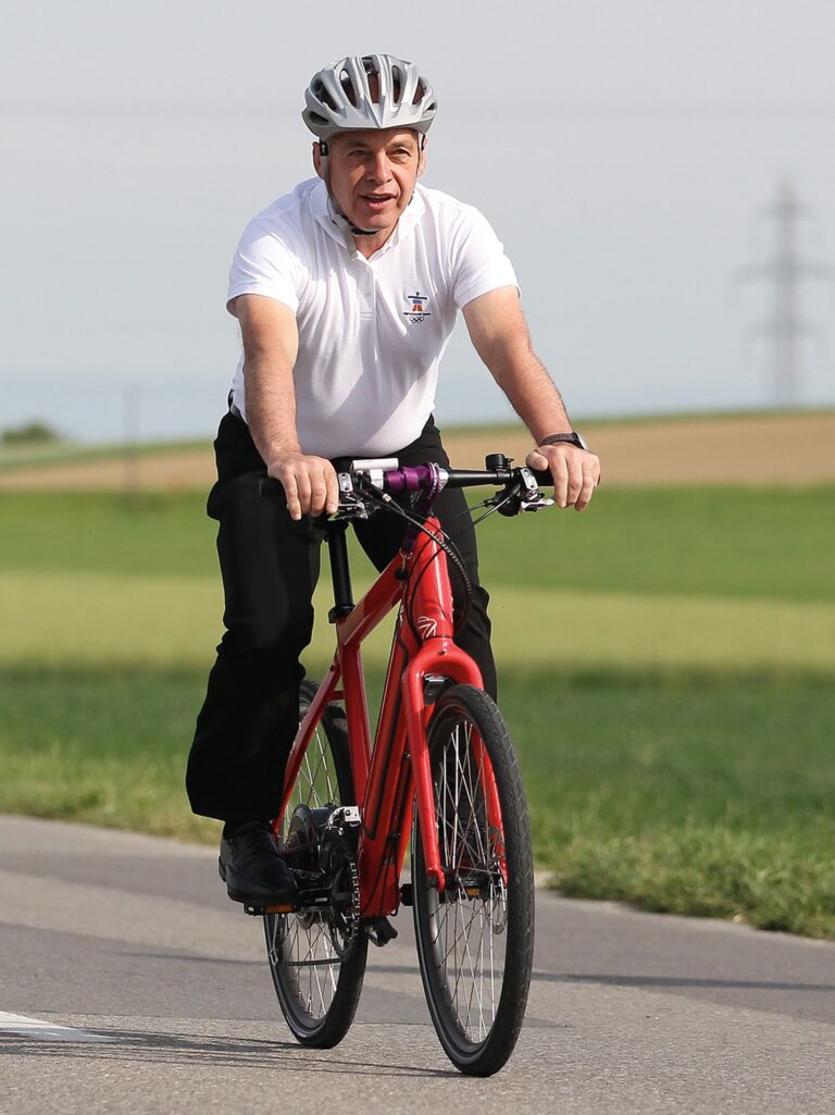 Swiss Defence Minister Maurer arrives on a bike for the Eidgenoessisches Feldschiessen in Tafers