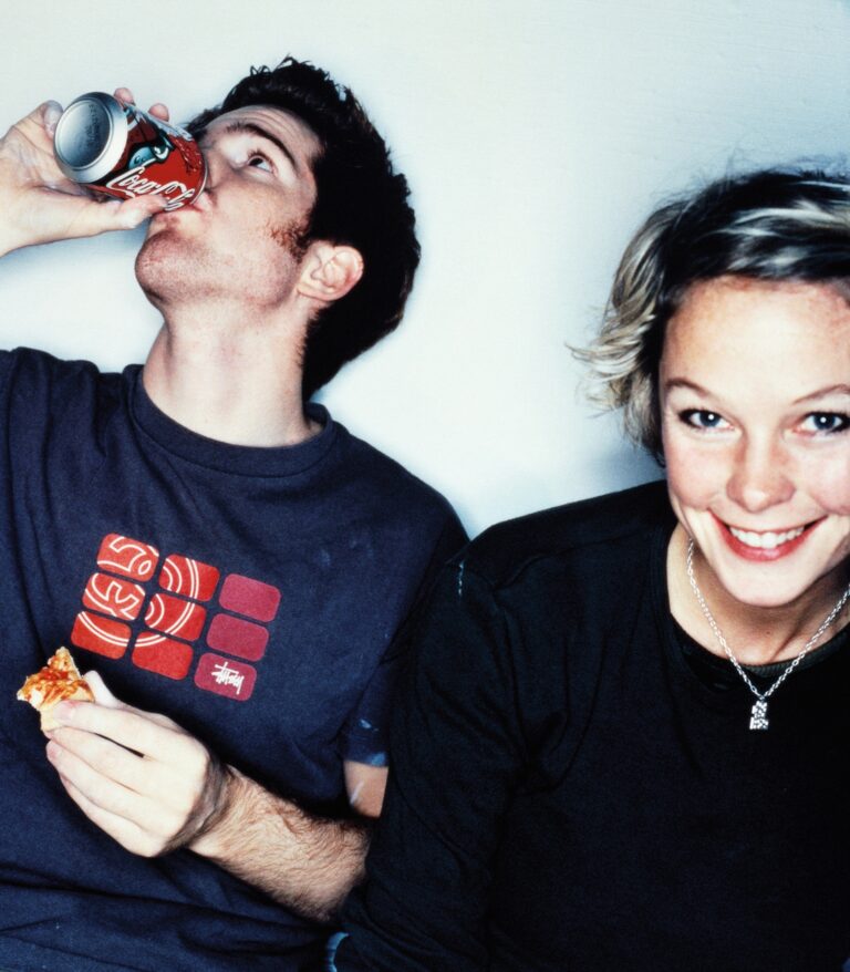 Young couple, he is eating and drinking. portrait