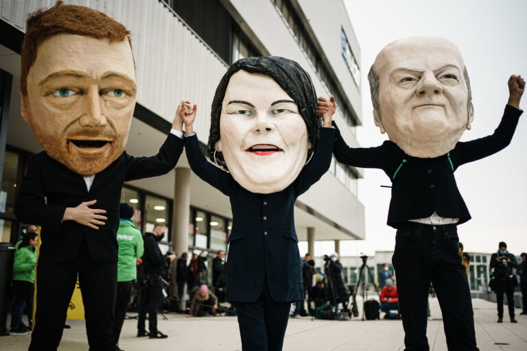 epa09518123 Activists of Campact wearing masks resembling (L-R) Free Democratic Party (FDP) chairman and faction chairman in the German parliament Bundestag Christian Lindner, Green party (Die Gruenen) co-chairwoman Annalena Baerbock and German Minister of Finance and Social Democratic Party (SPD) top candidate for the federal elections Olaf Scholz, demonstrate prior to the beginning of exploratory talks between the FDP, The Greens and the SPD, in Berlin, Germany, 11 October 2021. The Greens, SPD and FDP are meeting for coalition talks following Germany's recent parliamentary election. EPA/CLEMENS BILAN