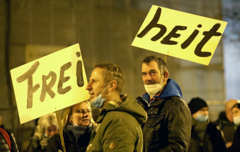 13.12.2021, Mecklenburg-Vorpommern, Rostock: Teilnehmer versammeln sich zu einer Demonstration gegen Corona-Maßnahmen, auf Schildern steht «Freiheit». Auf dem Veranstaltungsgelände müssen die Demonstranten wegen des Coronavirus einen Mund-Nasenschutz tragen. Zudem gilt das Abstandsgebot. In mehreren Städten Deutschlands haben Menschen gegen die Corona-Maßnahmen demonstriert. Foto: Bernd Wüstneck/dpa-Zentralbild/dpa +++ dpa-Bildfunk +++ (KEYSTONE/DPA/Bernd Wüstneck)