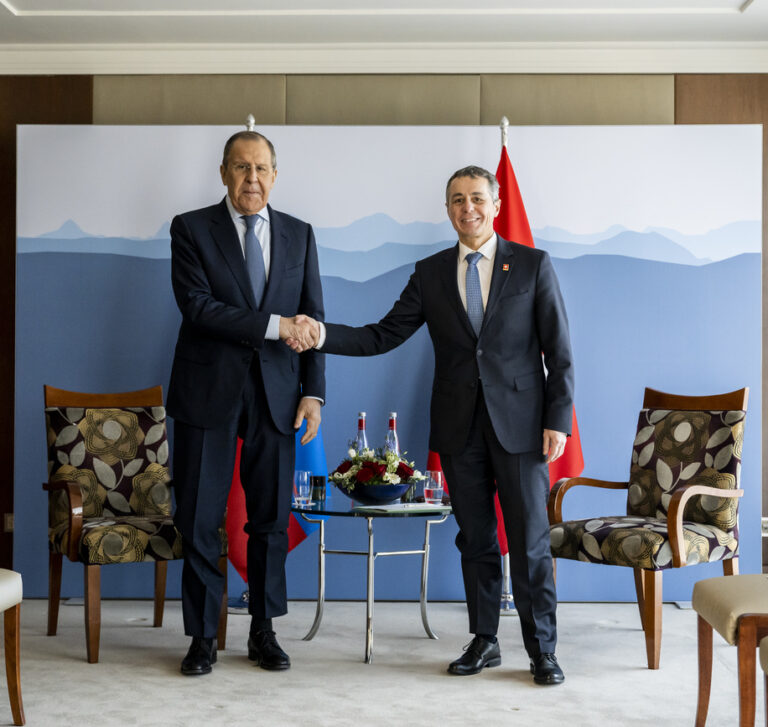 Russian Foreign Minister Sergei Lavrov, left, speaks to Switzerland's President and head of the Federal Department of Foreign Affairs Ignazio Cassis, right, on the sidelines of the US - Russia summit in Geneva, Switzerland, Friday, January 21, 2022. (KEYSTONE/Pool/Jean-Christophe Bott)