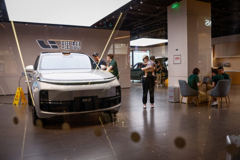 epa10794261 A man looks at a Li L9 SUV at a showroom in Beijing, China, 10 August 2023 (issued 11 August 2023). China's output and sales of passenger cars went down 4.3 percent and 3.4 percent respectively in July, year-on-year, the China Association of Automobile Manufacturers said, as passenger car production reached 2.12 million units with sales hitting 2.1 million units last month. EPA/MARK R. CRISTINO