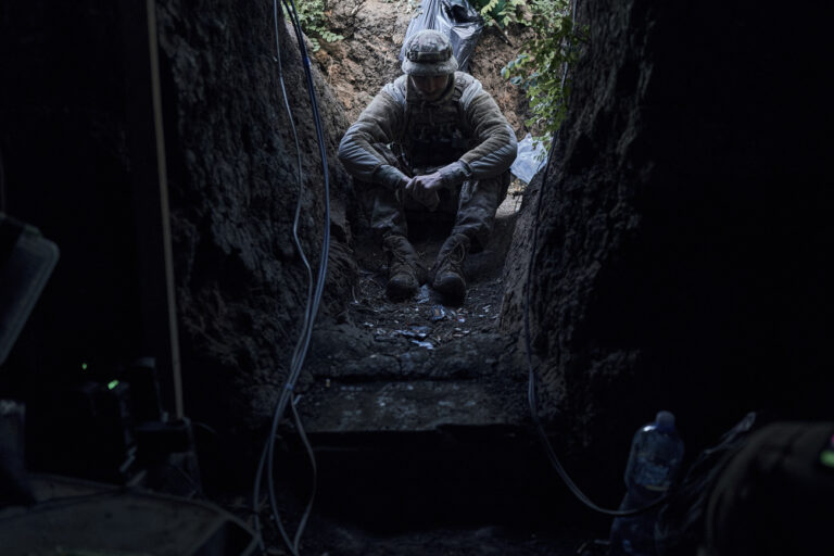 A soldier of Ukraine's 3rd Separate Assault Brigade rests at a shelter near Bakhmut, the site of fierce battles with the Russian forces in the Donetsk region, Ukraine, Sunday, Sept. 3, 2023. (AP Photo/Libkos)