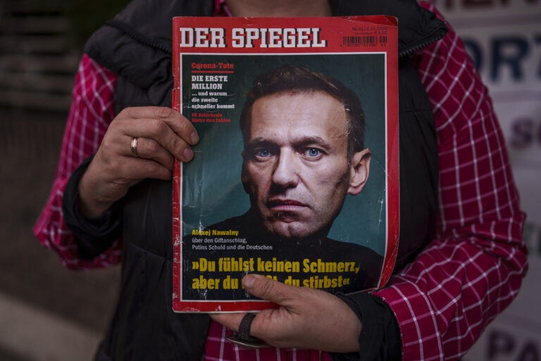 A woman holds a magazine with a portrait of Russian opposition leader Alexei Navalny in front of the Russian Embassy in Madrid, Spain, Friday, Feb. 16, 2024. Alexei Navalny, who crusaded against official corruption and staged massive anti-Kremlin protests as President Vladimir Putin's fiercest foe, has died in the Arctic penal colony where he was serving a 19-year sentence. That's according to Russia's prison agency. He was 47. (AP Photo/Manu Fernandez)