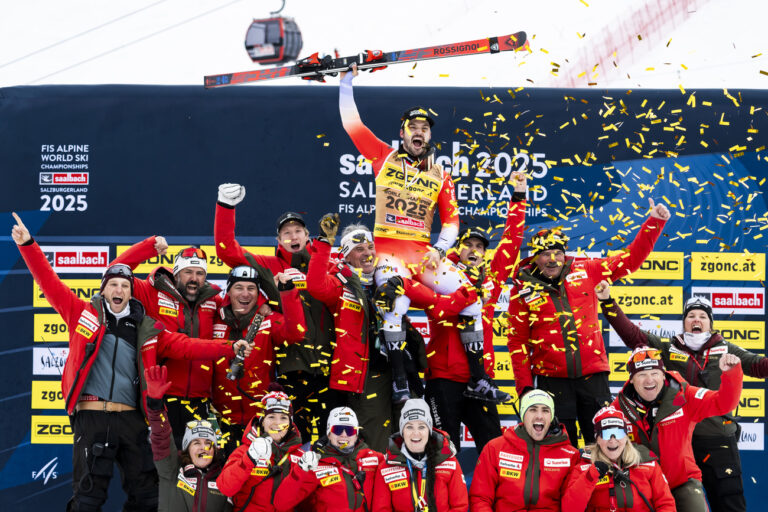 Gold medalist Loic Meillard of Switzerland celebrates with Swiss team members during the medals ceremony of the men's Slalom race at the 2025 FIS Alpine World Ski Championships, in Saalbach-Hinterglemm, Austria, Sunday, February 16, 2025. (KEYSTONE/Jean-Christophe Bott)