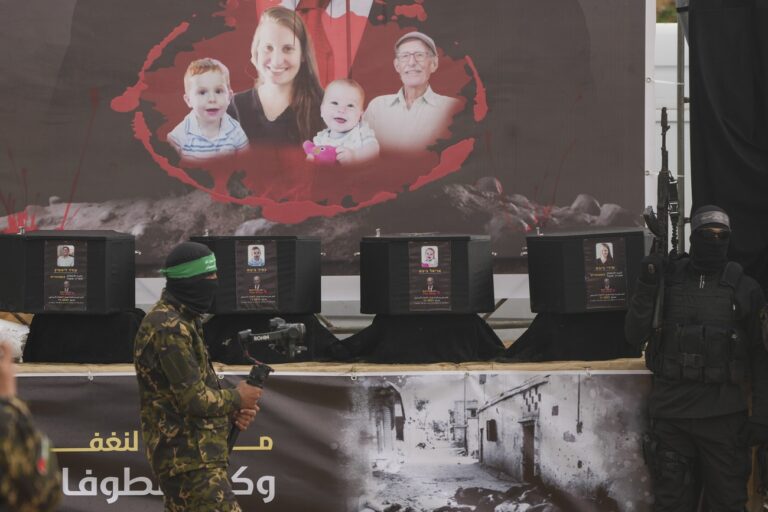 The coffins containing the bodies, from right to left, Shiri Bibas, her two children, Ariel and Kfir and Oded Lifshitz, who was 83 when he was abducted, are displayed on a stage before being handed over to the Red Cross by Hamas and Islamic Jihad in Khan Younis, southern Gaza Strip, Thursday, Feb. 20, 2025. (AP Photo/Abdel Kareem Hana)