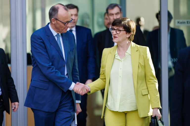 epa11949326 Chairman of the Christian Democratic Union (CDU) party and faction Friedrich Merz (front-L) and Social Democratic Party (SPD) co-chairwoman Saskia Esken (front-R) shake hands in front of Social Democratic Party (SPD) co-chairman Lars Klingbeil (back-L) and State Premier of Bavaria Markus Soeder (back-R) after a press conference during ongoing exploratory talks on the premises of the German parliament, the Bundestag, in Berlin, Germany, 08 March 2025. Germany's Christian Democratic Union (CDU) and Social Democratic Party (SPD) continue exploratory talks on forming a potential governing coalition. EPA/CLEMENS BILAN