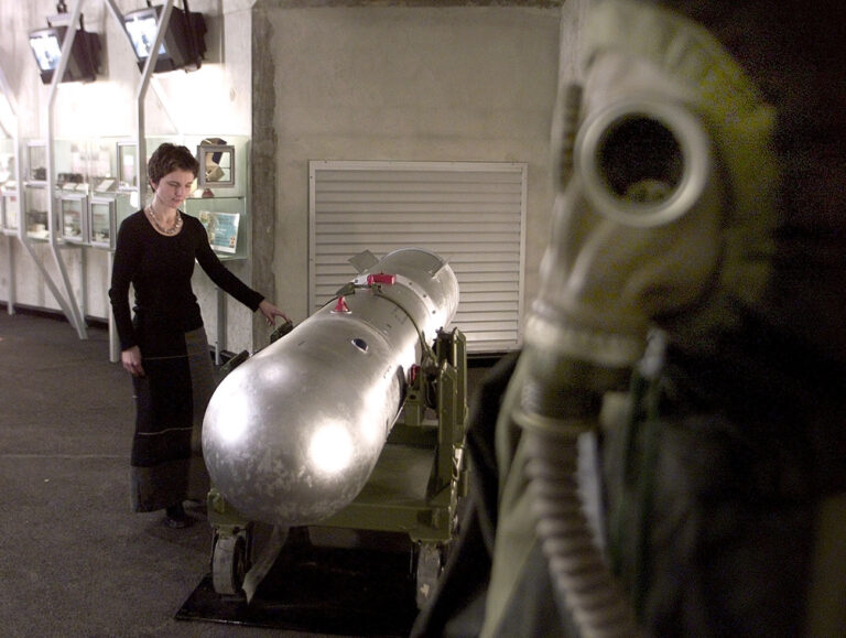 Caen War Memorial employee Magalie Bignon works on a disarmed atomic bomb from the U.S National Atomic Museum and which arrived in France for display at the memorial, Monday March 11, 2002 in Caen, Normandy. The hydrogen bomb is to be featured in a permanent exhibit dedicated to the Cold War and the threat of nuclear holocaust. The 3.6-meter (11.8-feet) bomb weighs 453 kiograms (997 pounds) and would have been loaded into a B-52 bomber. (KEYSTONE/AP Photo/Franck Prevel)