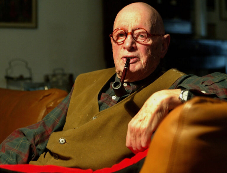 File - In this April 4, 2004 file picture screen-play author  Wolfgang Menge, smokes a pipe in his house in Berlin. According to German dapd news agency, Menge died in Berlin, he was 88 his family confirmed Thursday Oct. 18 2012.   (AP Photo/dapd/ Robert Michael,File)