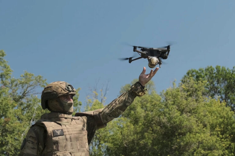 In this photo taken from video released by Russian Defense Ministry press service on Thursday, Sept. 19, 2024, a Russian serviceman launches a drone at an undisclosed location in Ukraine. (Russian Defense Ministry Press Service via AP)