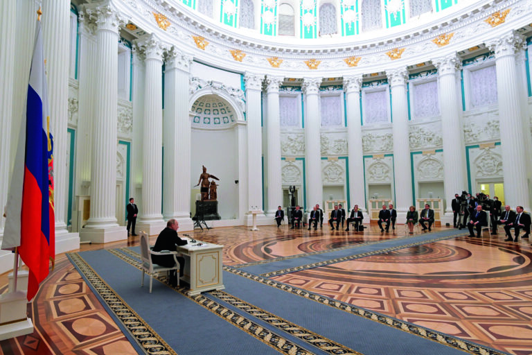 Russian President Vladimir Putin, left, chairs a Security Council meeting in the Kremlin in Moscow, Russia, Monday, Feb. 21, 2022. Putin has convened top officials to consider recognizing the independence of separatist regions in eastern Ukraine. Such a move would ratchet up tensions with the West amid fears that the Kremlin could launch an invasion of Ukraine imminently. (Sputnik, Kremlin Pool Photo via AP)